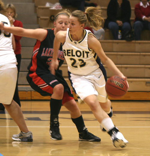 Mary Parker'10 dribbling a basketball down the court.