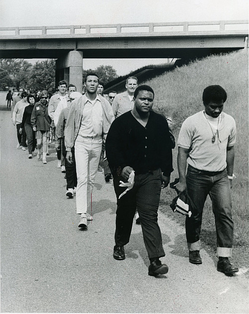 Students, including Michael Young'69, far right, and President Miller Upton, march to raise money for the Mississippi Tutoring Center.