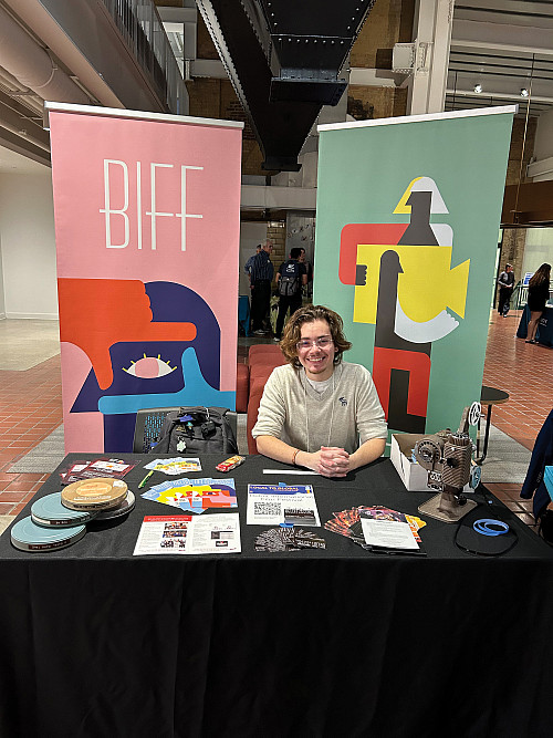 Nico Doret'24 at a booth for the Beloit International Film Festival