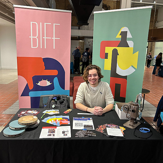 Nico Doret'24 at a booth for the Beloit International Film Festival