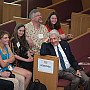 The Alumni Assembly audience, including President Bierman at right, reacts to alumni stories shared in Eaton Chapel during Reunion.